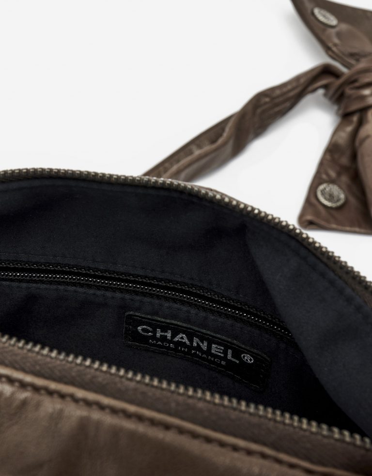 Inside of a pre-loved Chanel Girl Medium Lambskin in Brown and Black on SACLÀB