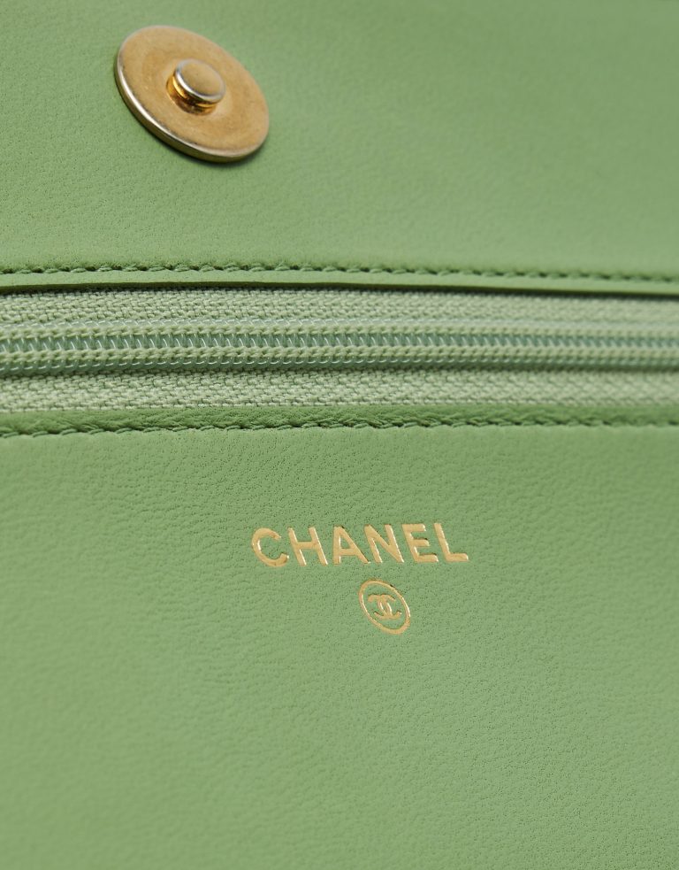 Chanel logo detail of a pre-loved Chanel Boy Wallet on Chain Lambskin in Light Green on SACLÀB