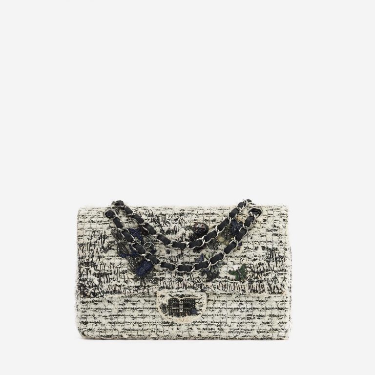A pre-loved Chanel 2.55 Reissue 226 Tweed White Black Garden Charms on SACLÀB