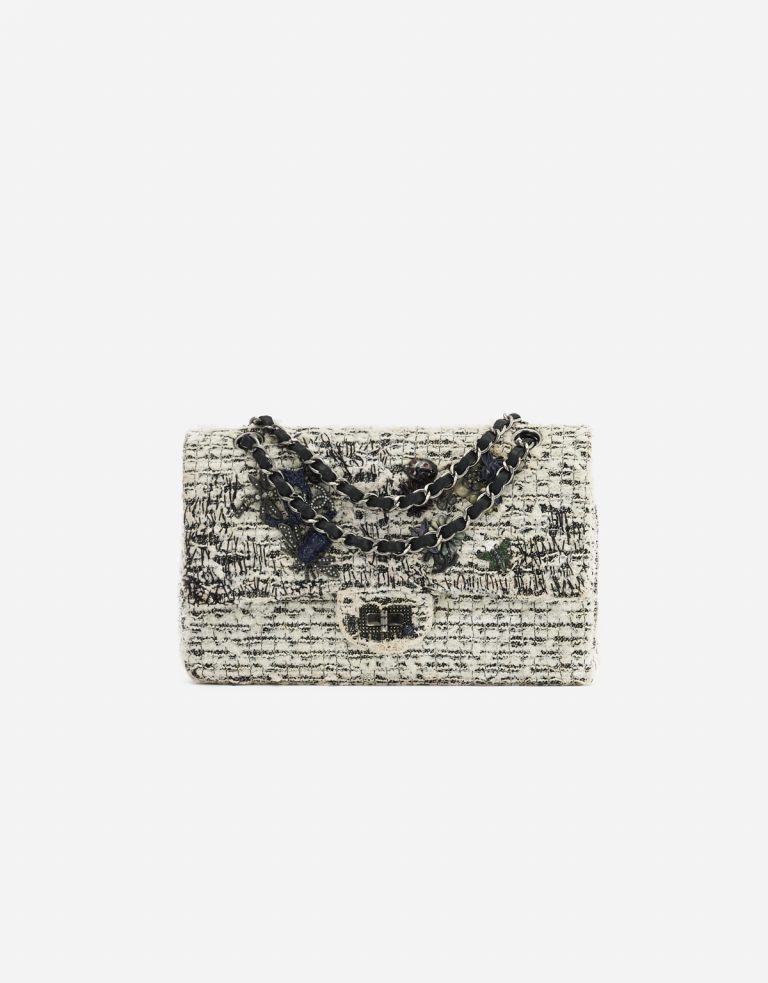 A pre-loved Chanel 2.55 Reissue 226 Tweed White Black Garden Charms on SACLÀB