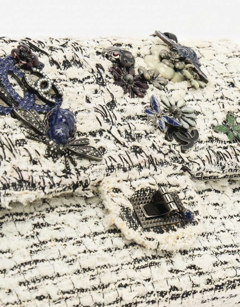 Hardware on a pre-loved Chanel 2.55 Reissue 226 Tweed White Black Garden Charms on SACLÀB