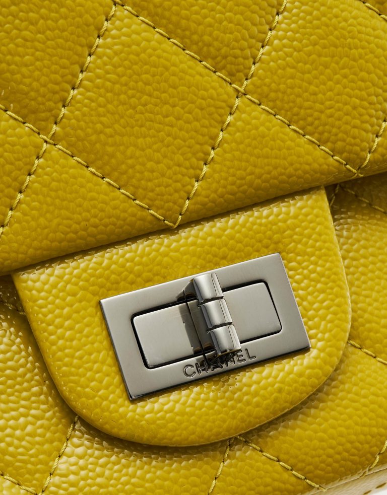 A pre-loved Chanel 2.55 Reissue 227 Patent Caviar Yellow on SACLÀB