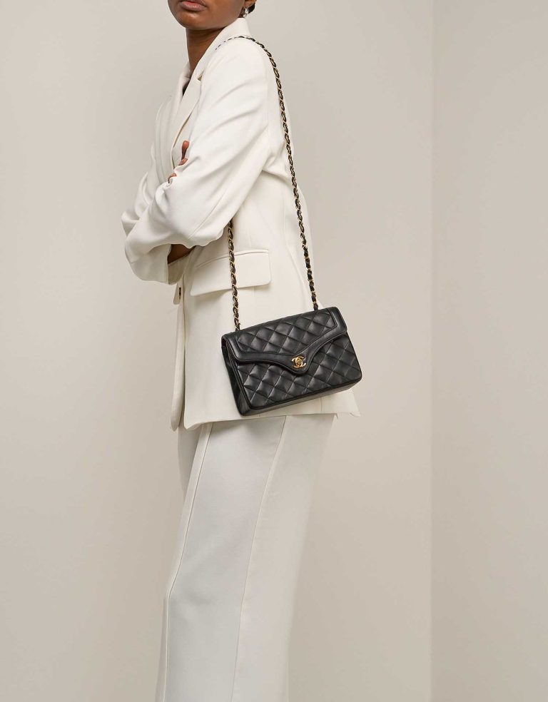 Chanel Timeless Flap Bag Small Lamb Black on Model | Sell your designer bag