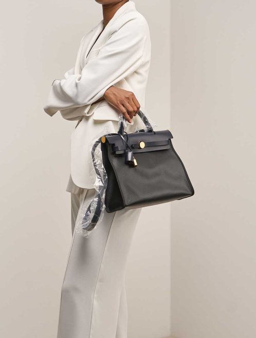 Hermès Herbag 31 Coated Toile / Vache Hunter Black / Écru / Bleu Indigo on Model | Sell your designer bag