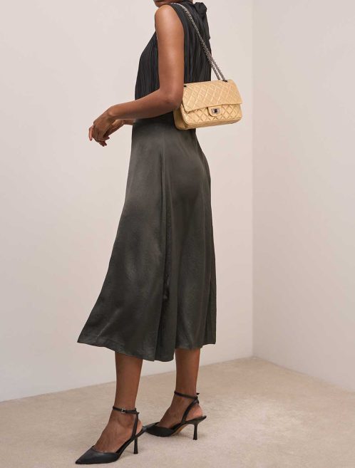Chanel 2.55 Reissue 224 Aged Calf Gold on Model | Sell your designer bag