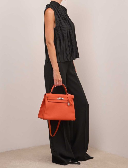 Hermès Kelly 32 Togo Orange H on Model | Sell your designer bag