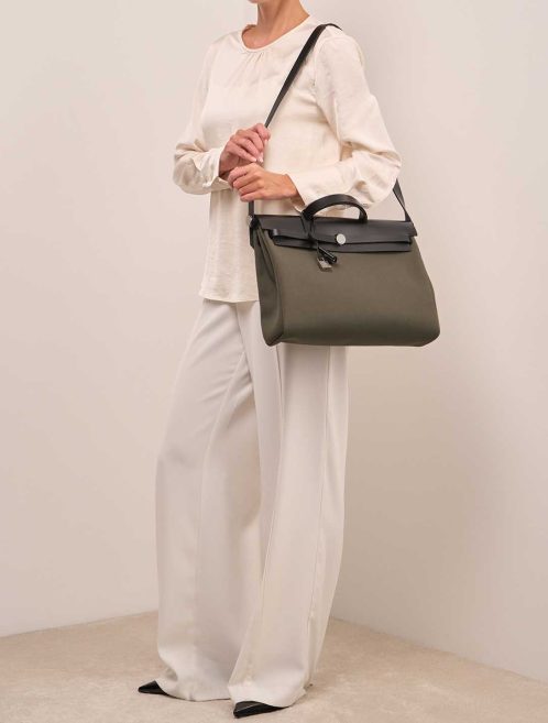 Hermès Herbag 39 Vache Hunter / Toile Black / Vert Militaire on Model | Sell your designer bag