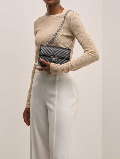 Chanel 2.55 Reissue Mini Calf Black on Model | Sell your designer bag