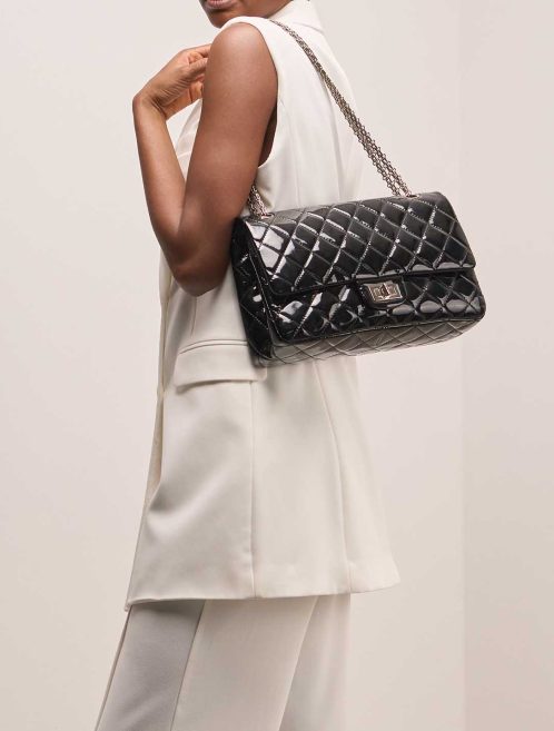 Chanel 2.55 Reissue 228 Patent Black on Model | Sell your designer bag